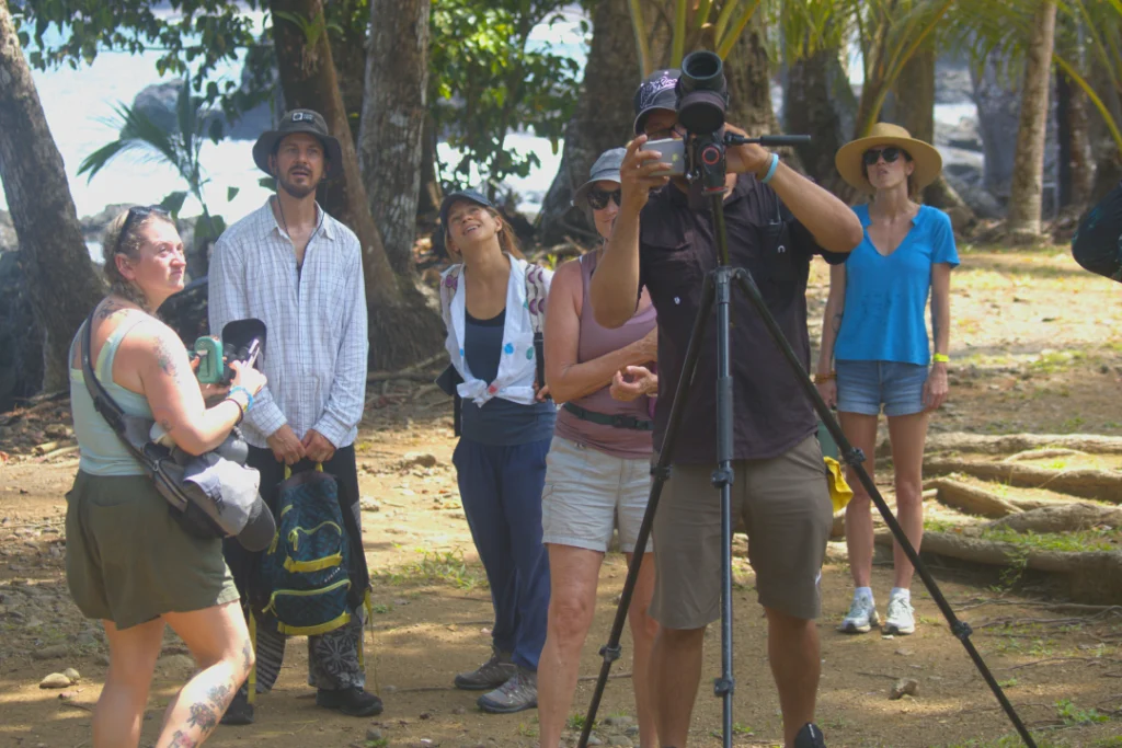 Naturalist guide and travelers using a spotting scope in Corcovado